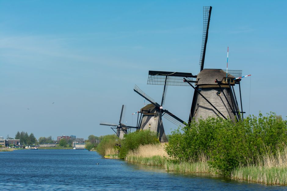 Traditional windmills along the canal in Kinderdijk, Netherlands, showcasing classic Dutch countryside beauty.